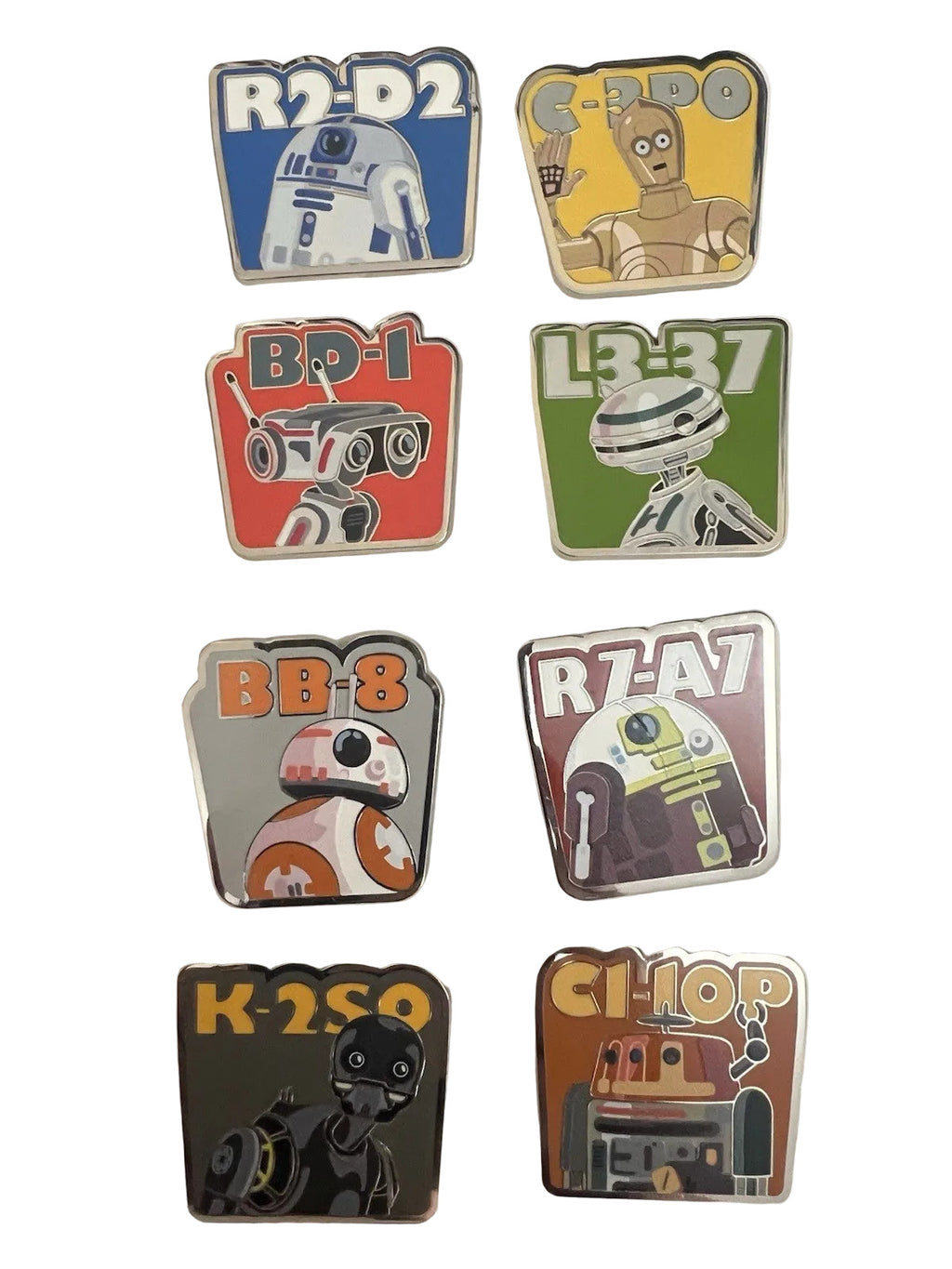 Set of robot-themed pins on a white card with a black background