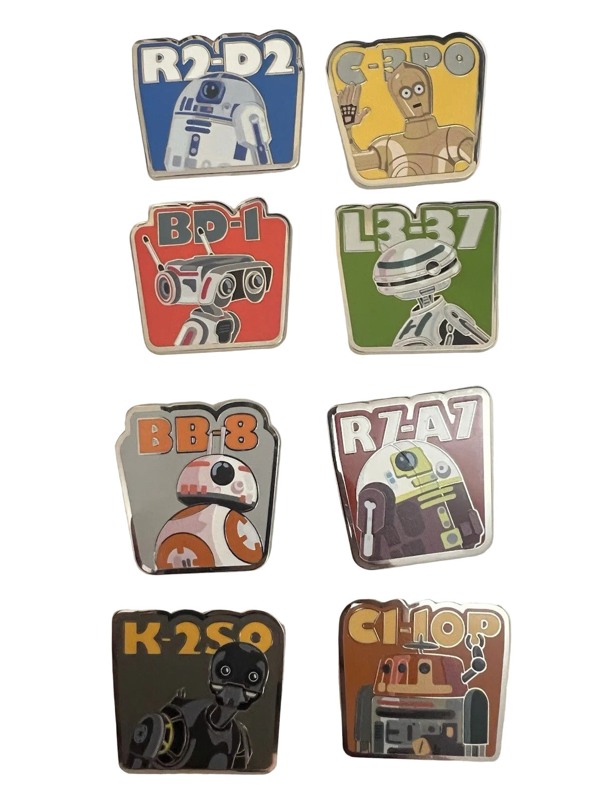 Set of robot-themed pins on a white card with a black background
