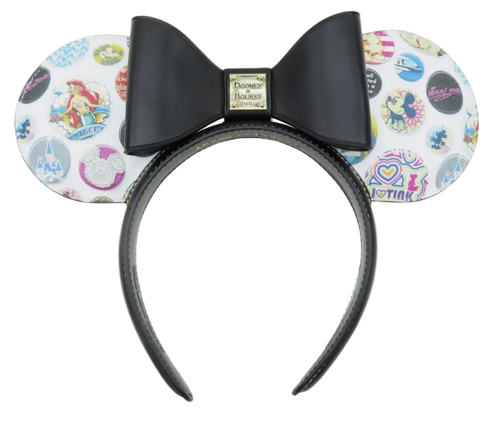 A Minnie Mouse-themed headband with a large black bow and ears covered in colorful Disney-themed graphics, shown against a white background.
