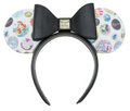 A Minnie Mouse-themed headband with a large black bow and ears covered in colorful Disney-themed graphics, shown against a white background.