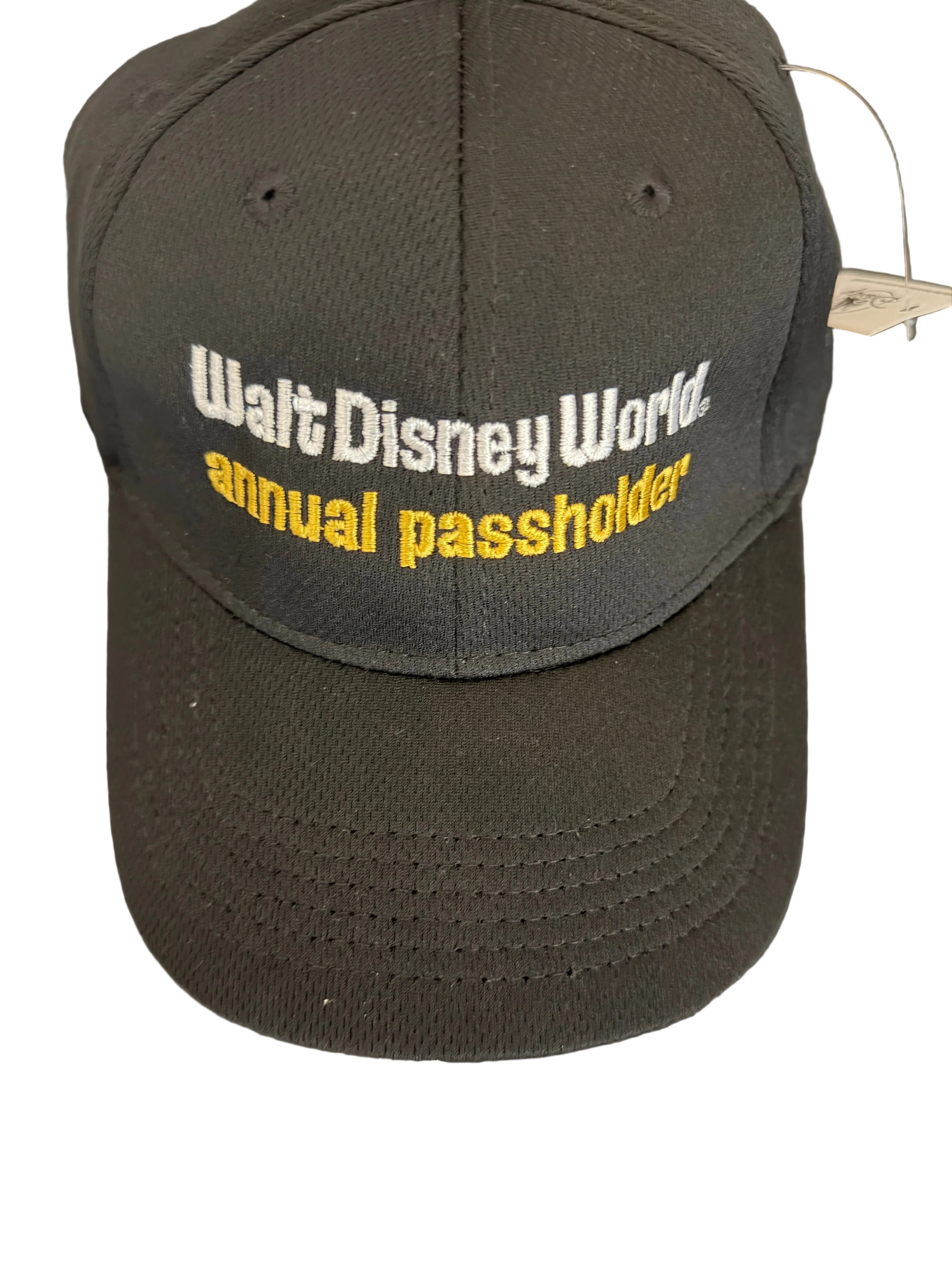 Black cap with 'Walt Disney World Annual Passholder' text on a white surface
