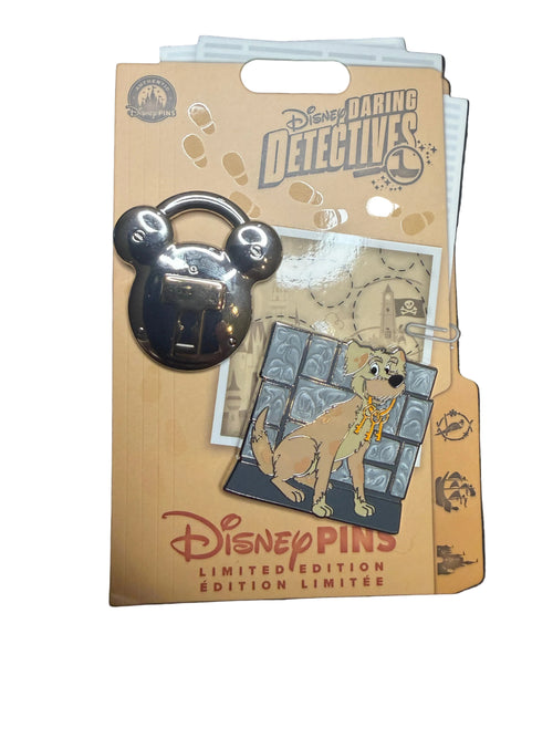 Disney pins and packaging on a white surface