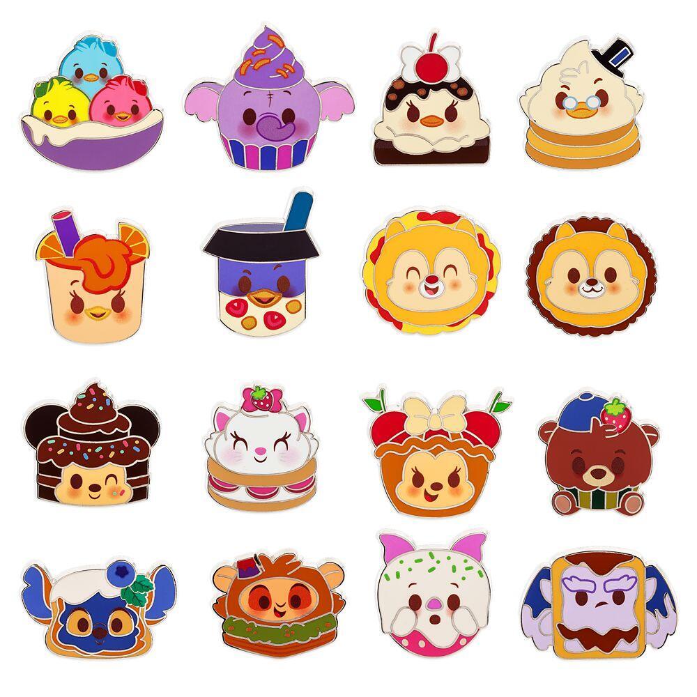 Collection of colorful cartoon character pins on a white background