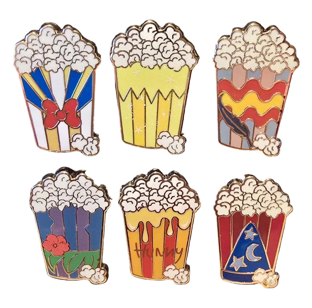 Set of six popcorn-themed pins on a white background